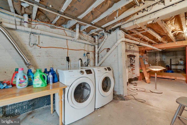 clothes washing area with washer and clothes dryer