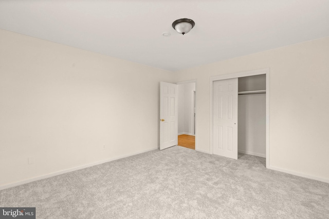 unfurnished bedroom featuring a closet, carpet flooring, and baseboards