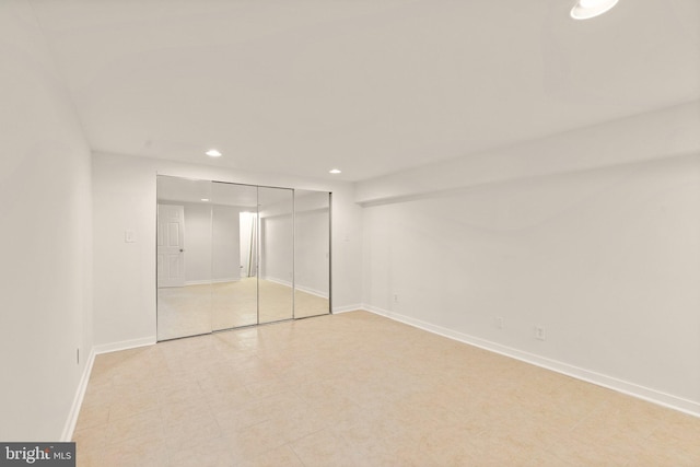 unfurnished bedroom with baseboards, a closet, and recessed lighting