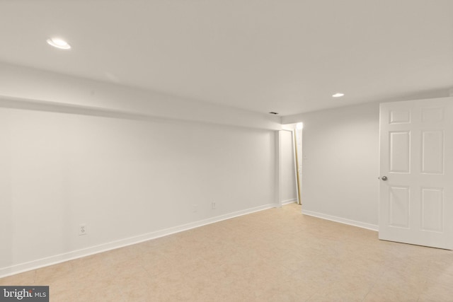 finished below grade area featuring baseboards and recessed lighting