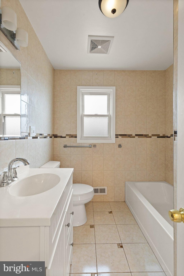 full bathroom with visible vents, tile walls, toilet, and tile patterned floors