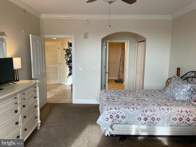 bedroom with ornamental molding, light colored carpet, and ceiling fan