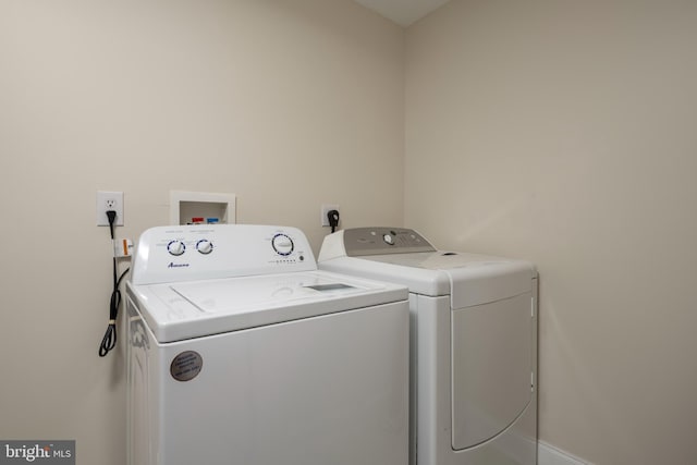 clothes washing area with separate washer and dryer