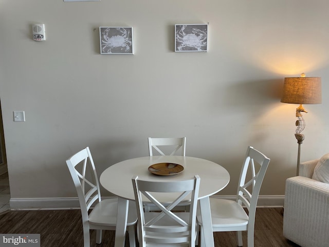 dining room with dark hardwood / wood-style flooring