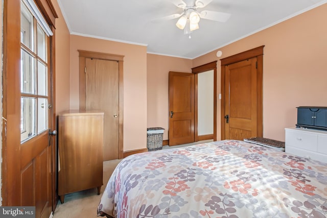 carpeted bedroom featuring ceiling fan and ornamental molding