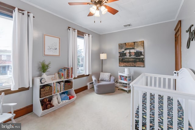 bedroom with a crib, ornamental molding, carpet flooring, and baseboard heating