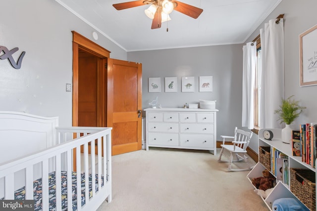 carpeted bedroom featuring ornamental molding and ceiling fan