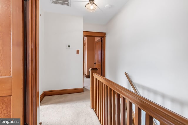 hallway with light colored carpet