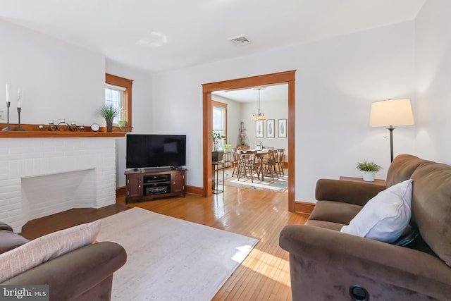 living room featuring hardwood / wood-style flooring and a fireplace