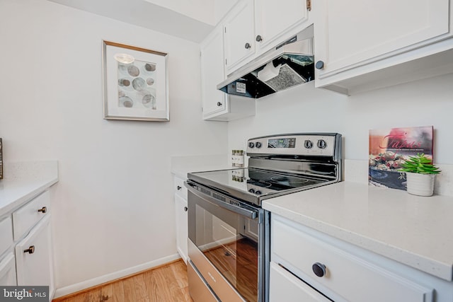 kitchen featuring light hardwood / wood-style floors, stainless steel range with electric cooktop, and white cabinets