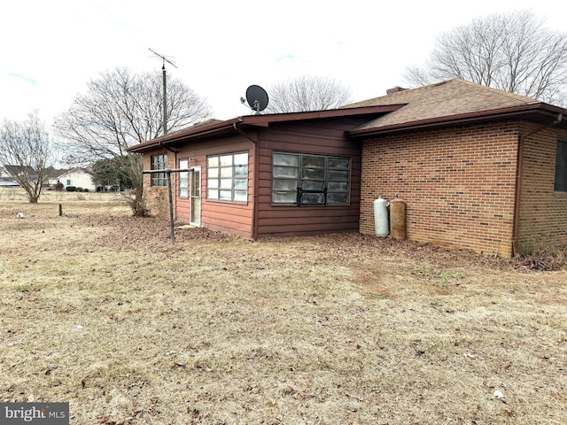 view of side of home with a lawn