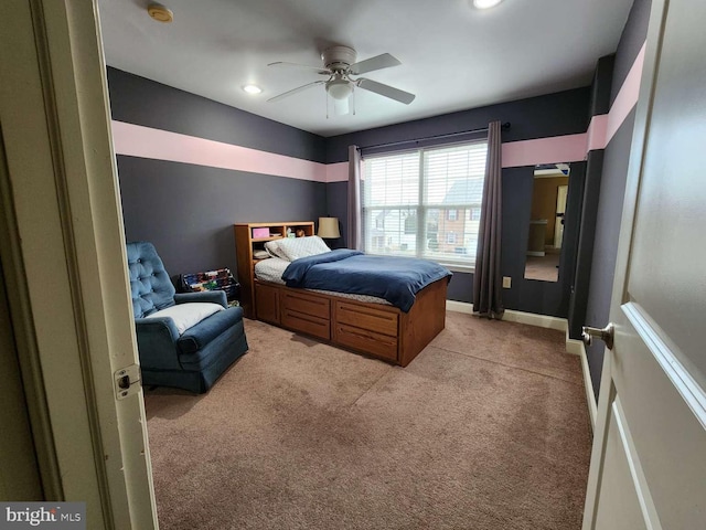 bedroom featuring ceiling fan and light carpet