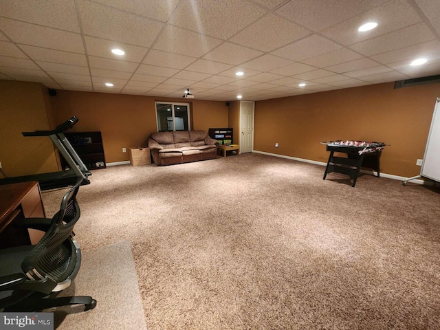 recreation room featuring carpet and a drop ceiling