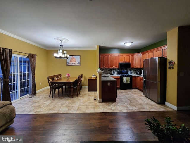 kitchen with crown molding, a center island, refrigerator, and black range with electric cooktop