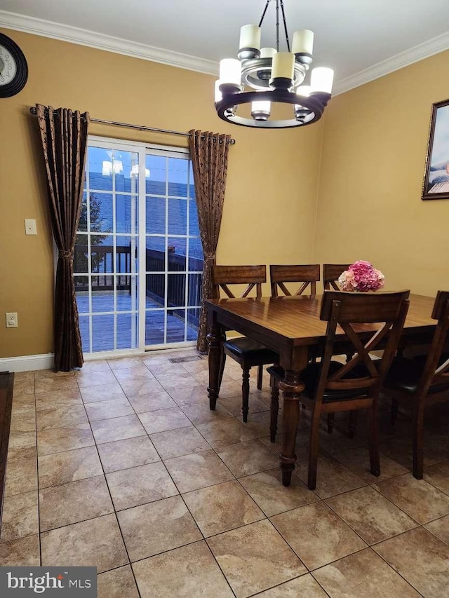 tiled dining room featuring a water view, ornamental molding, and an inviting chandelier