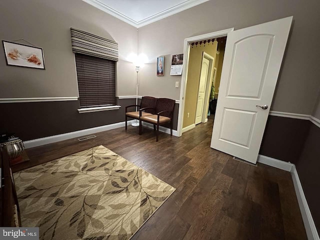 living area featuring crown molding and dark hardwood / wood-style floors