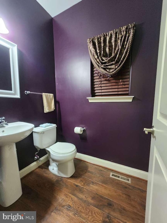 bathroom featuring toilet and hardwood / wood-style floors