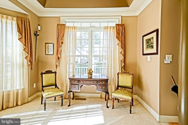 living area featuring carpet floors, baseboards, a tray ceiling, and ornamental molding