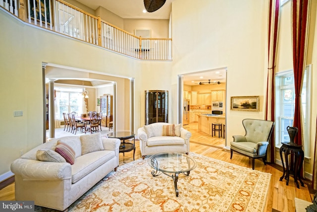 living area with light wood finished floors and baseboards