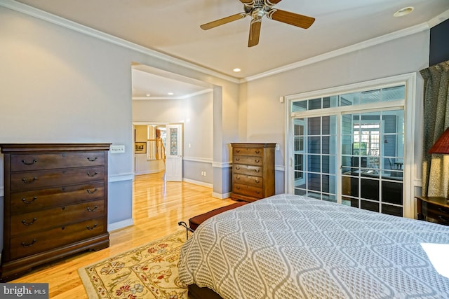 bedroom featuring light wood finished floors, baseboards, ceiling fan, ornamental molding, and access to exterior