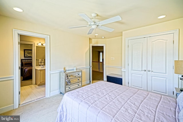 bedroom featuring ceiling fan, ensuite bathroom, recessed lighting, light carpet, and a closet