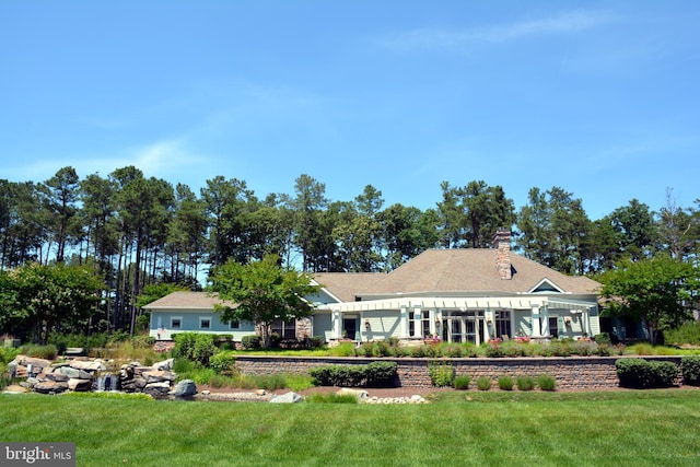 view of front of house with a front yard and a chimney