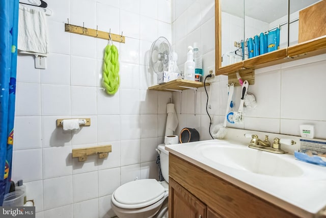 bathroom featuring vanity, tasteful backsplash, tile walls, and toilet