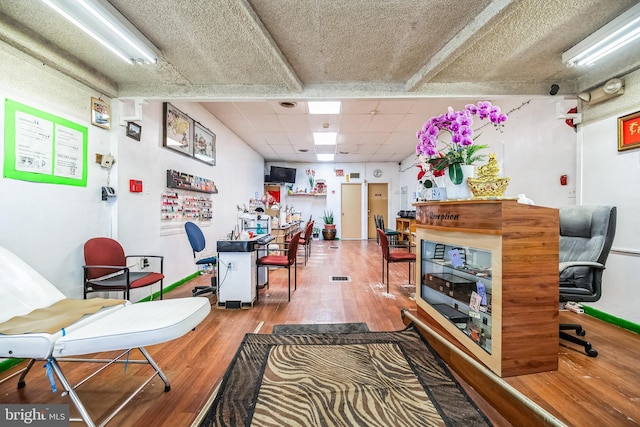 interior space with hardwood / wood-style floors and a drop ceiling