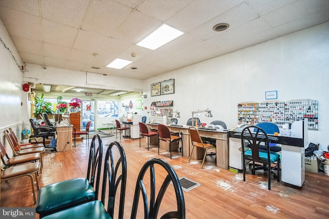 interior space featuring hardwood / wood-style flooring and a paneled ceiling