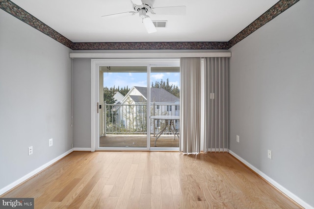 unfurnished room featuring visible vents, baseboards, ceiling fan, and wood finished floors