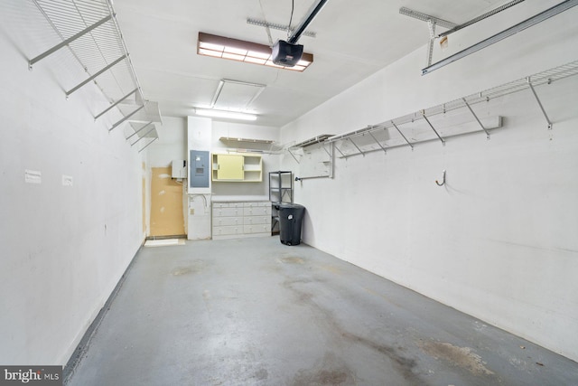 garage with electric panel and a garage door opener