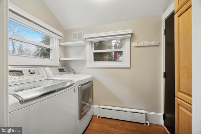 laundry room featuring separate washer and dryer, dark hardwood / wood-style floors, and baseboard heating