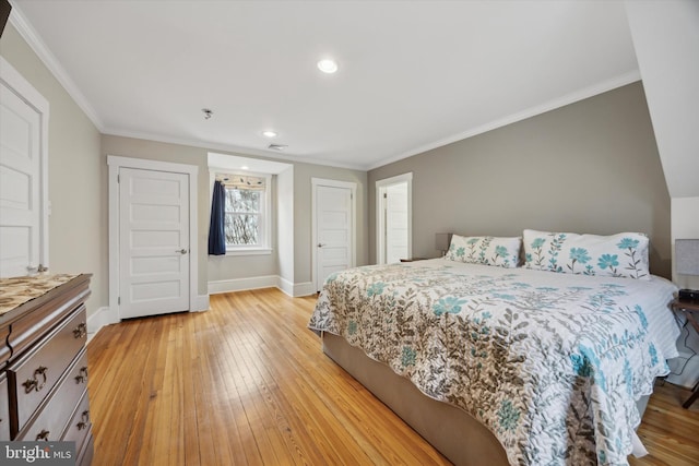 bedroom with ornamental molding and light hardwood / wood-style flooring