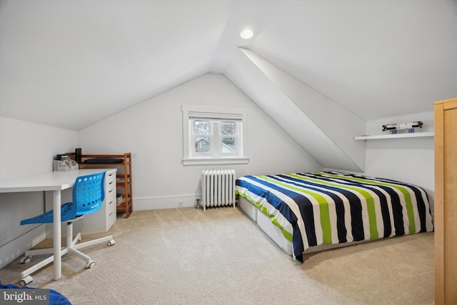 bedroom with radiator, vaulted ceiling, and light carpet