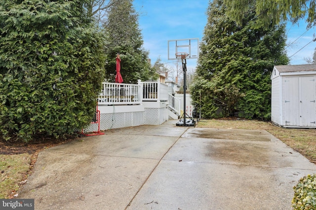 view of patio / terrace featuring a wooden deck and a storage unit