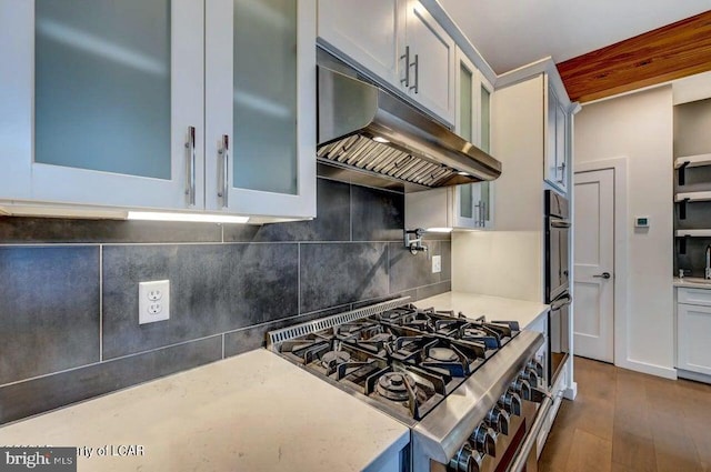 kitchen with white cabinetry, gas range, tasteful backsplash, dark hardwood / wood-style floors, and double oven