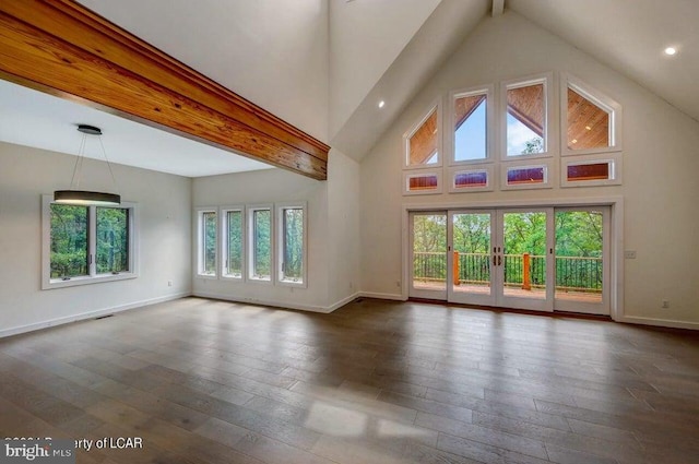 unfurnished living room featuring dark hardwood / wood-style flooring, high vaulted ceiling, and beam ceiling