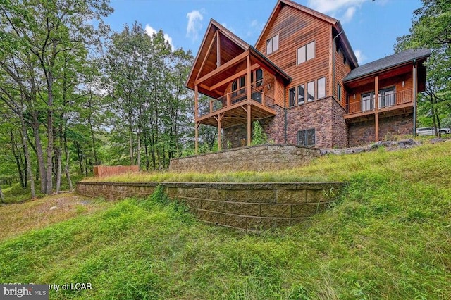 back of house with a balcony