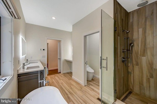 full bathroom featuring hardwood / wood-style flooring, vanity, separate shower and tub, and toilet