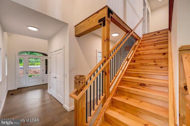 stairs featuring wood-type flooring