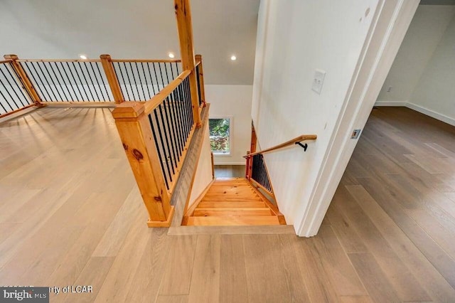 stairway with hardwood / wood-style floors