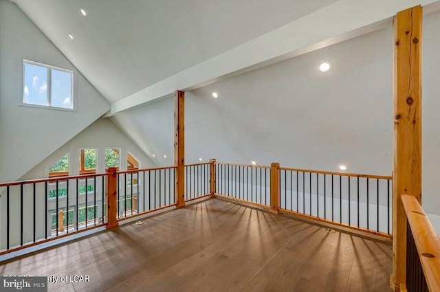 bonus room with beam ceiling, hardwood / wood-style flooring, and high vaulted ceiling