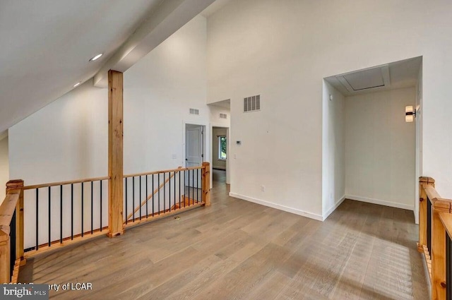 interior space featuring high vaulted ceiling and light hardwood / wood-style floors