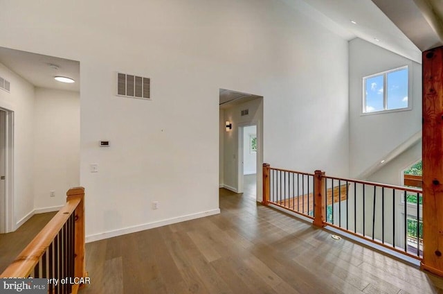 interior space featuring hardwood / wood-style flooring and a high ceiling