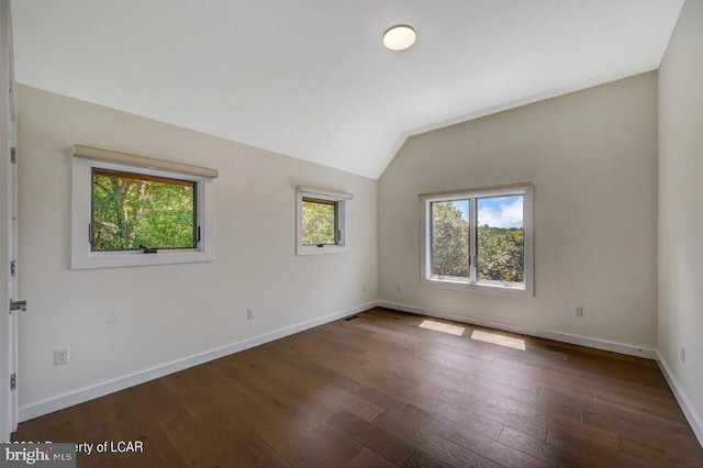 unfurnished room with vaulted ceiling and dark hardwood / wood-style floors