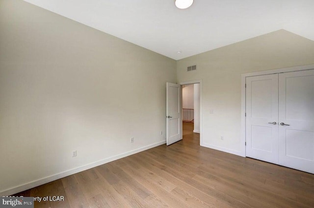 unfurnished bedroom featuring light hardwood / wood-style floors and a closet