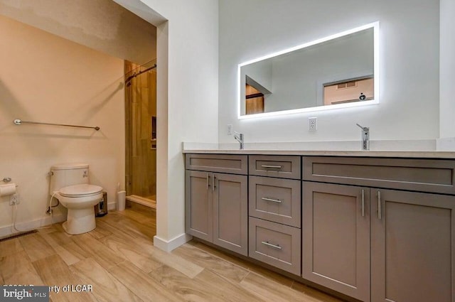 bathroom featuring vanity, toilet, a shower with shower curtain, and wood-type flooring