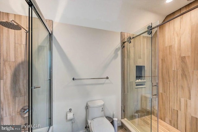 bathroom with toilet and walk in shower