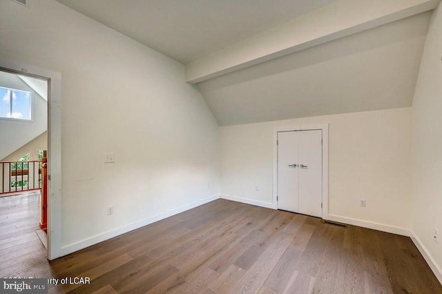 bonus room featuring vaulted ceiling with beams and hardwood / wood-style floors