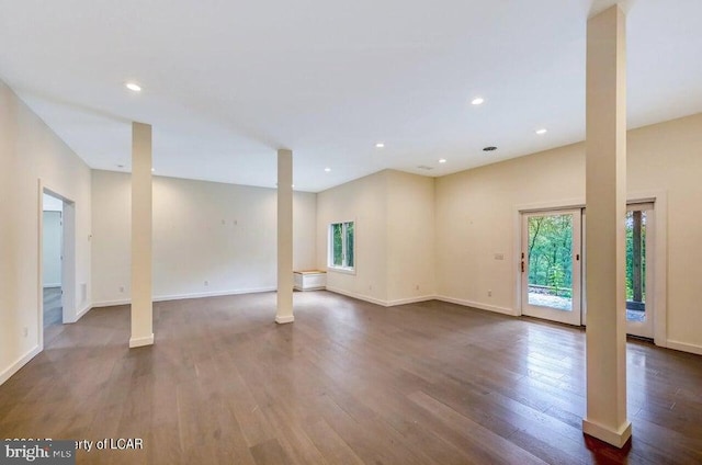 interior space with dark hardwood / wood-style flooring and ornate columns